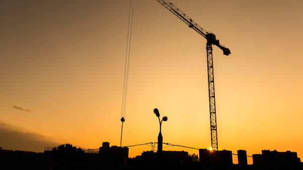 istock Silhouette of construction crane on the sunset background. 1371052760