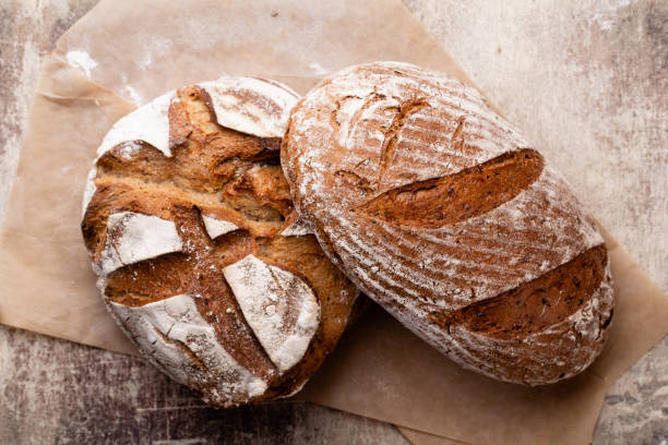 istock Assortment of baked bread on wooden table background. 1371052885