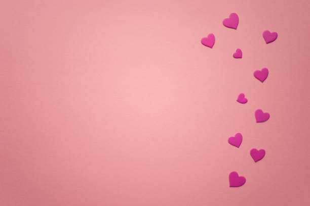 istock Magenta hearts on pink paper table. Copy space. 1371053441