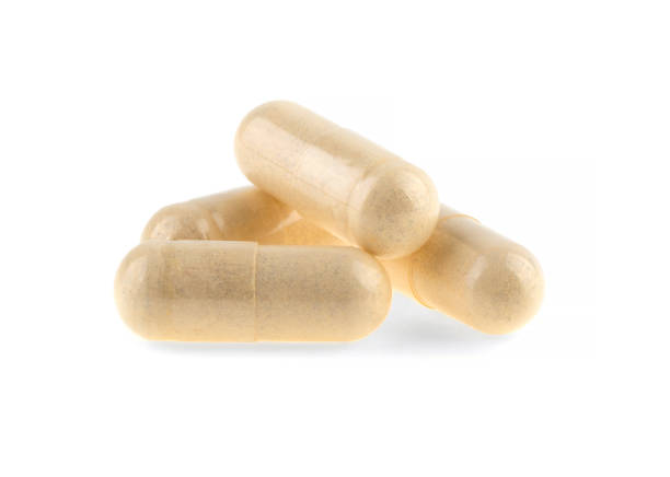 istock vitamins in medical capsules isolated on white background 1371054015