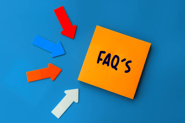 istock FAQ - frequently asked questions - concept of text on sticky note. Orange square sticky note and colorful arrows on blue background, top view 1371054201