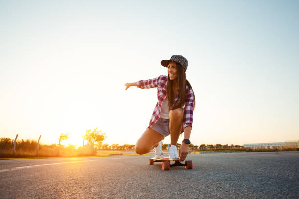 istock Young skater woman riding on her longboard 1371054793