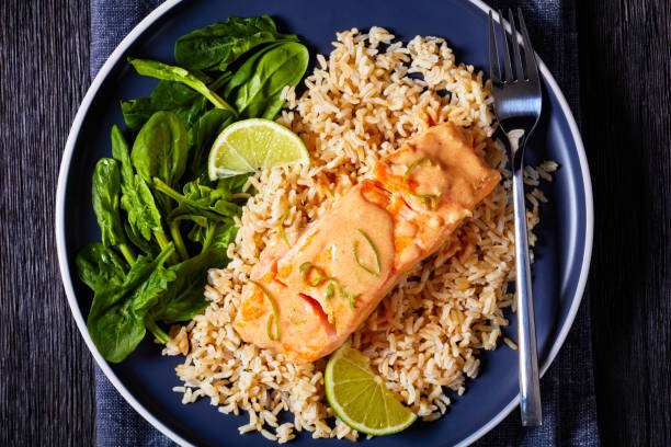 istock portion of cooked Salmon with rice and greens 1371054836
