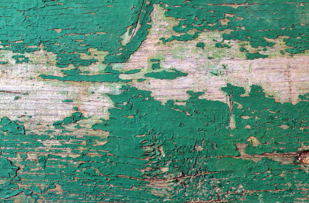 Old wooden board with old peeling green paint
