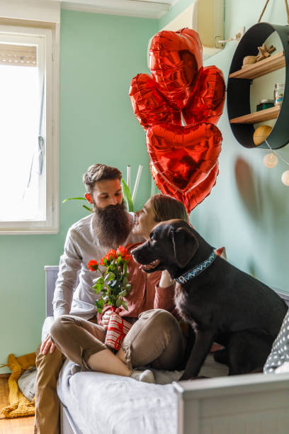 istock Couple sharing a romantic moment cuddling on bed on Valentine's day 1371055011