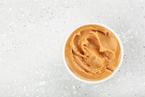 istock smooth peanut butter in bowl on gray background 1371055023