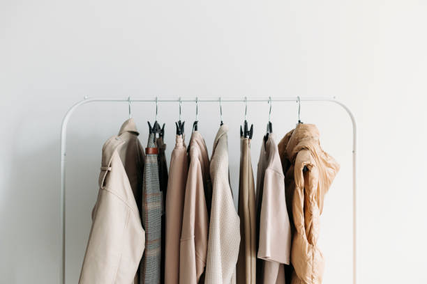capsule clothes of beige coloron a rack. closeup - casaco peça de roupa imagens e fotografias de stock