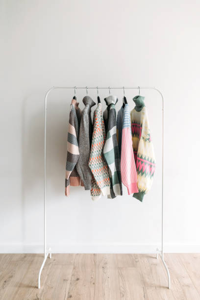 Several colorful patterned clothes on a rack. Showroom stock photo