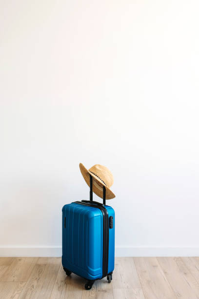 istock Suitcase with hat on white background. travel concept 1371058124