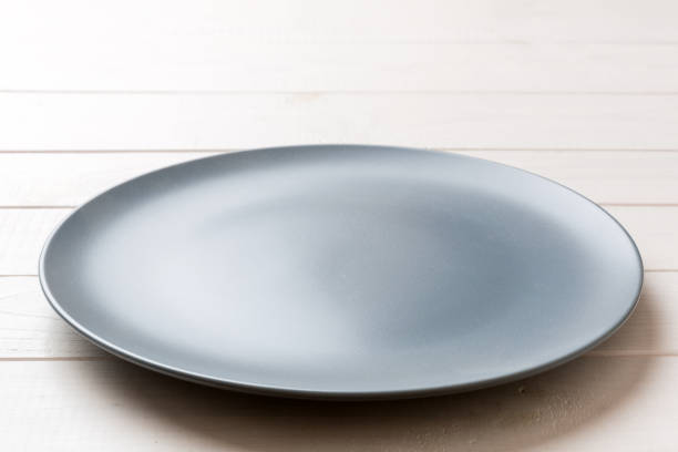 istock Perspective view of empty grey plate on cement background. Empty space for your design 1371058362