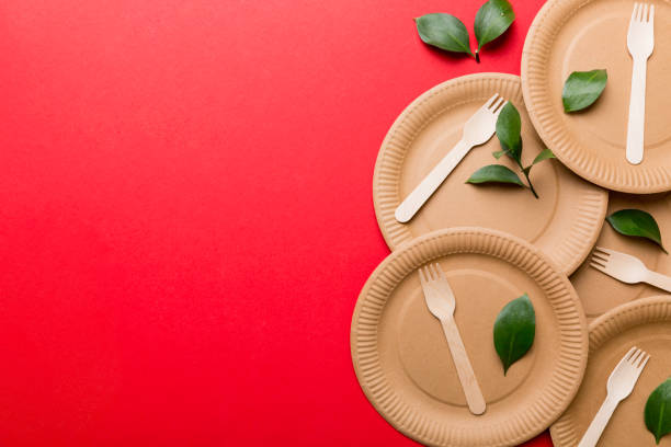 istock set of empty reusable disposable eco-friendly plates, cups, utensils on light white colored table background. top view. Biodegradable craft dishes. Recycling concept. Close-up 1371058453