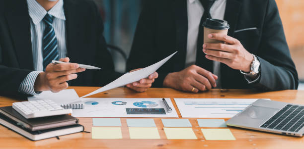 istock Partner colleagues are talking about the results in the document on hand and together analyze the work data about the company's financial statements. 1371058478