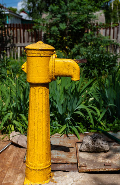 istock an old column with yellow water stands in the garden 1371059920