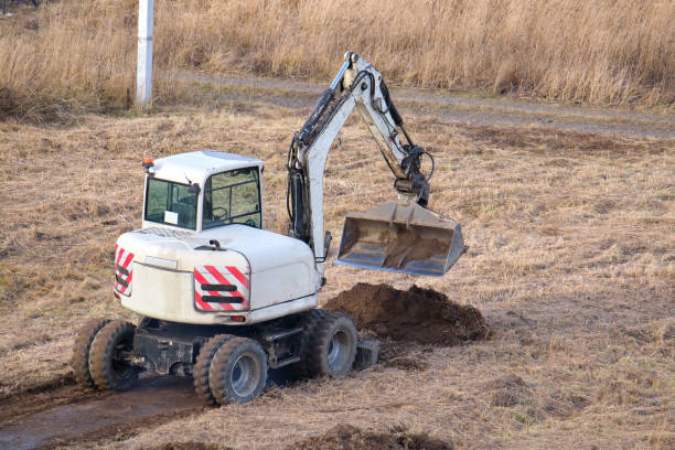 istock Earth moving tractor preparing place for future house foundation construction. Leveling soil for building new home 1371060046
