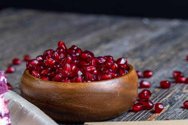istock scattered pomegranate seeds on a wooden board 1371060201