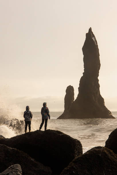 istock Two women watching at the Reynisdrangar at the sunset 1371061073