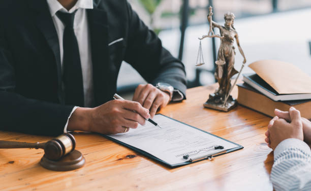 istock Lawyer working with client at table in office, focus on hands 1371061296