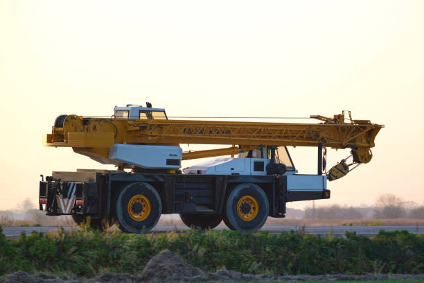 istock Heavy duty mobile lifting crane driving on intercity road at sunset 1371062821