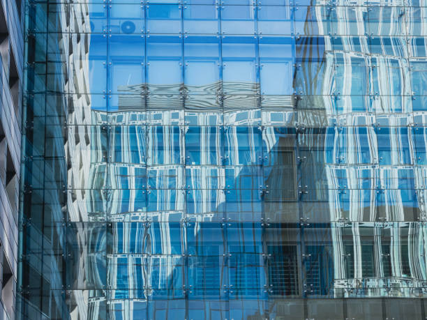 istock modern glass building mirror reflections. front view of modern glass building 1371063516