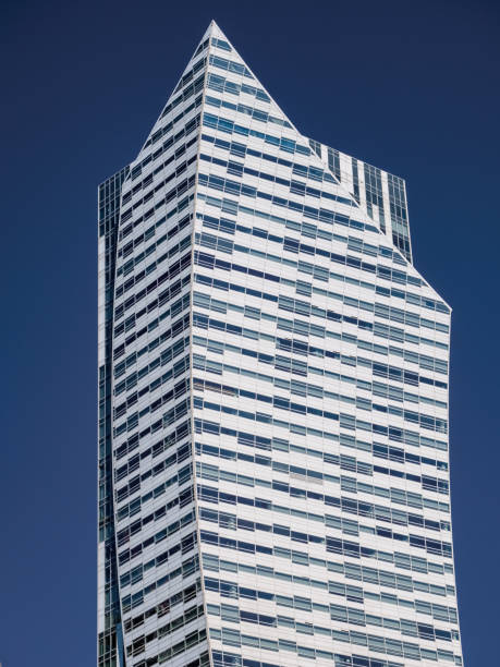 istock front view on modern white skyscraper over blue sky background, vertical photo 1371063679