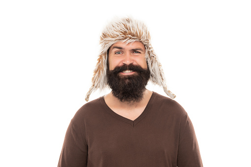 smiling brutal hipster with beard in earflape hat isolated on white background, casual.