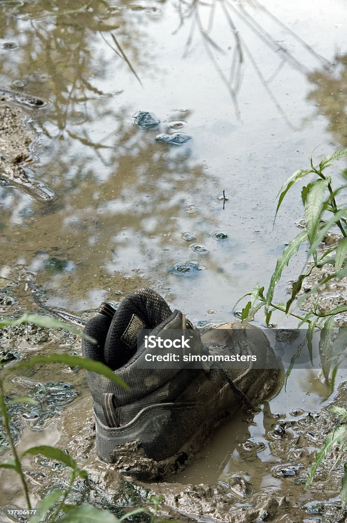 stuck in the mud solitary walking boot stuck in the mud Absence Stock Photo