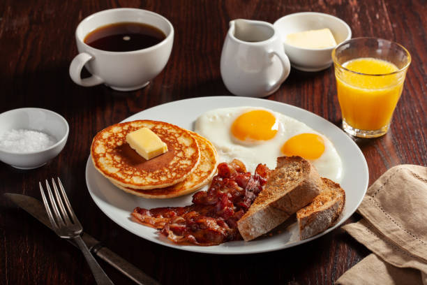 istock traditional full american breakfast eggs pancakes with bacon and toast 1371065001