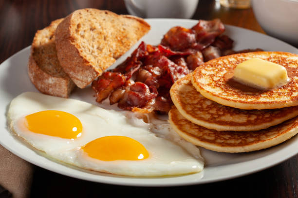 istock traditional full american breakfast eggs pancakes with bacon and toast 1371065031
