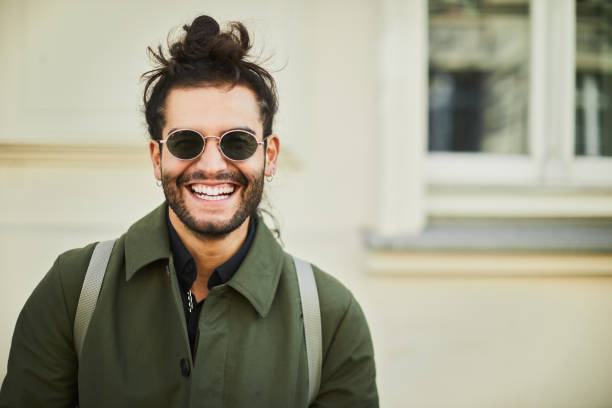 Photograph of a man that is looking at the camera.\nFront view.