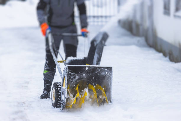 istock Process of removing snow with portable blower machine, worker dressed in overall workwear with gas snow blower removal on the street during winter 1371066127
