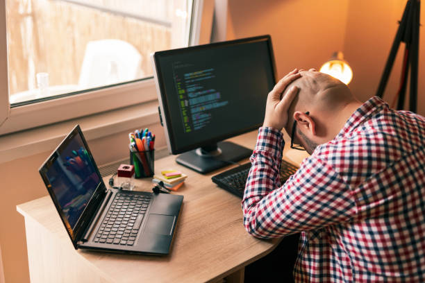 Software developer stressed out at work stock photo