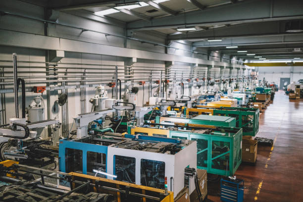High angle aerial view of an empty electronic industrial building with injection molding CNC machine parts putting, checking and testing industrial equipment cables for serving the white goods and electric electronics sectors in modern large wire and cable manufacturing plant factory warehouse
