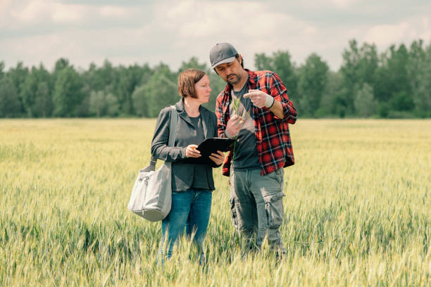 istock Mortgage loan officer assisting farmer in financial allowance application process 1371068960