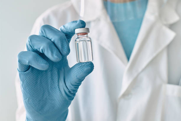 istock Doctor holding vaccine vial 1371069144