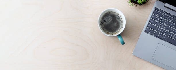 istock Working business space. Online education, training. Laptop, coffee on a wooden table, top view, copy space, banner. 1371069509