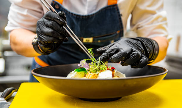 istock Chef's hands in gloves cooking crepe pancake on plate in kitchen 1371070214