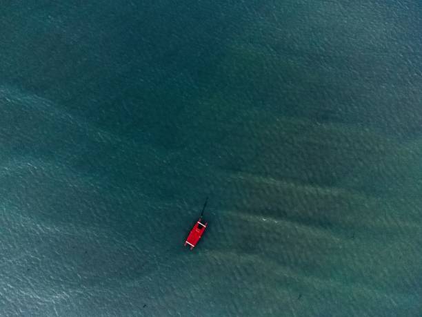 istock red boat in the sea 1371070319