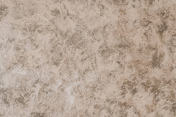 istock A painted plaster wall texture. An old beige wall background. 1371070659