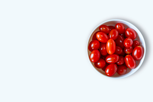 Red Tomatoes on a plate isolated white background, Red Grape Tomatoes in a Bowl, Copy space