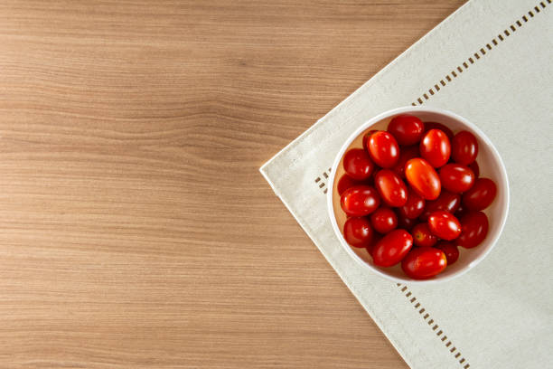 Tomatoes on a wooden table, Top view, Red Tomatoes on a plate, Red Grape Tomatoes in a Bowl Tomatoes on a wooden table, Top view, Red Tomatoes on a plate, Red Grape Tomatoes in a Bowl grape tomato stock pictures, royalty-free photos & images