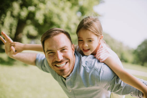 istock Father with daughter having fun at the park 1371072701