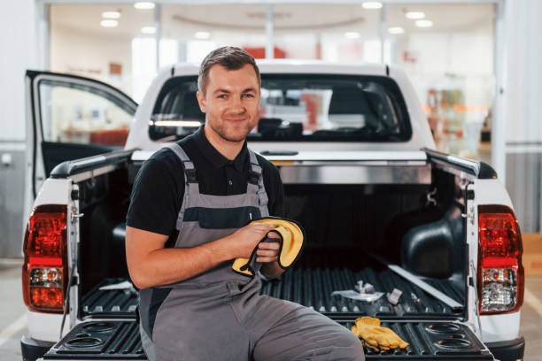 istock Successful work. Man in uniform is in the auto service 1371073013