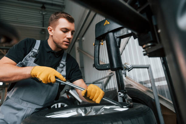 istock Employee at work. Man in uniform is in the auto service 1371073663