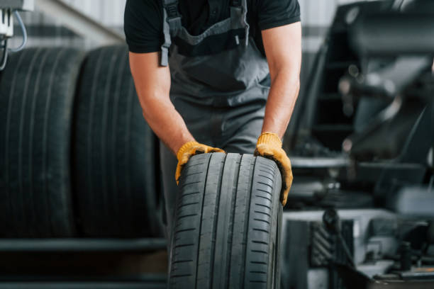 istock Front view. Man in uniform is working in the auto service 1371073867