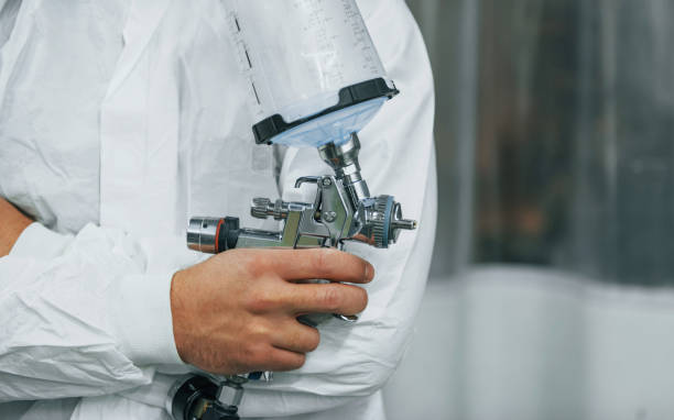 istock Ready for the painting. Man in uniform is working in the auto service 1371074202