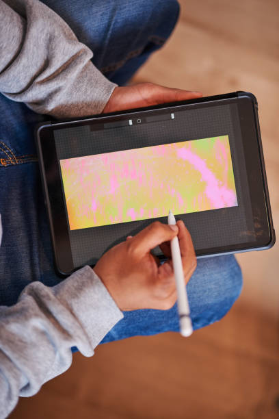 istock A close up shot of a man's hands using a stylus to draw on a tablet 1371074329