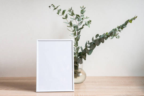 istock Minimalist home decor with empty frame mock-up on white wall background 1371075462