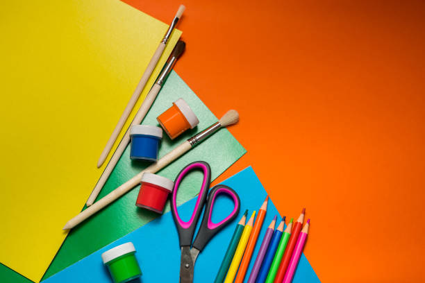 istock Back to school. Items for the school on a orange table. 1371075530