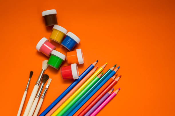 istock Back to school. Items for the school on a orange table. 1371075747