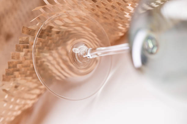 Green olive splashing in a glass of Martini.
